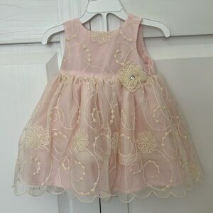 Beautiful dress for a little girl in cream and pink color